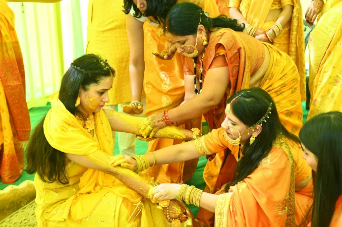 A group of women dressed in yellow and orange